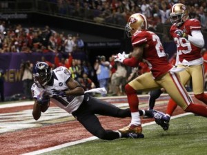 Baltimore Ravens' Jones dives into the end zone for a second quarter touchdown past San Francisco 49ers' and Culliver in the NFL Super Bowl XLVII football game in New Orleans