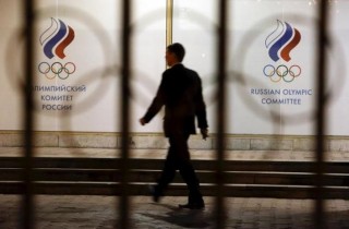 A man walks in front of the Russian Olympic Committee headquarters building, which also houses the management of Russian Athletics Federation in Moscow